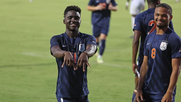Mouhameth Thiam reacts after scoring a goal during the Virginia men's soccer exhibition match against Villanova at Klockner Stadium.